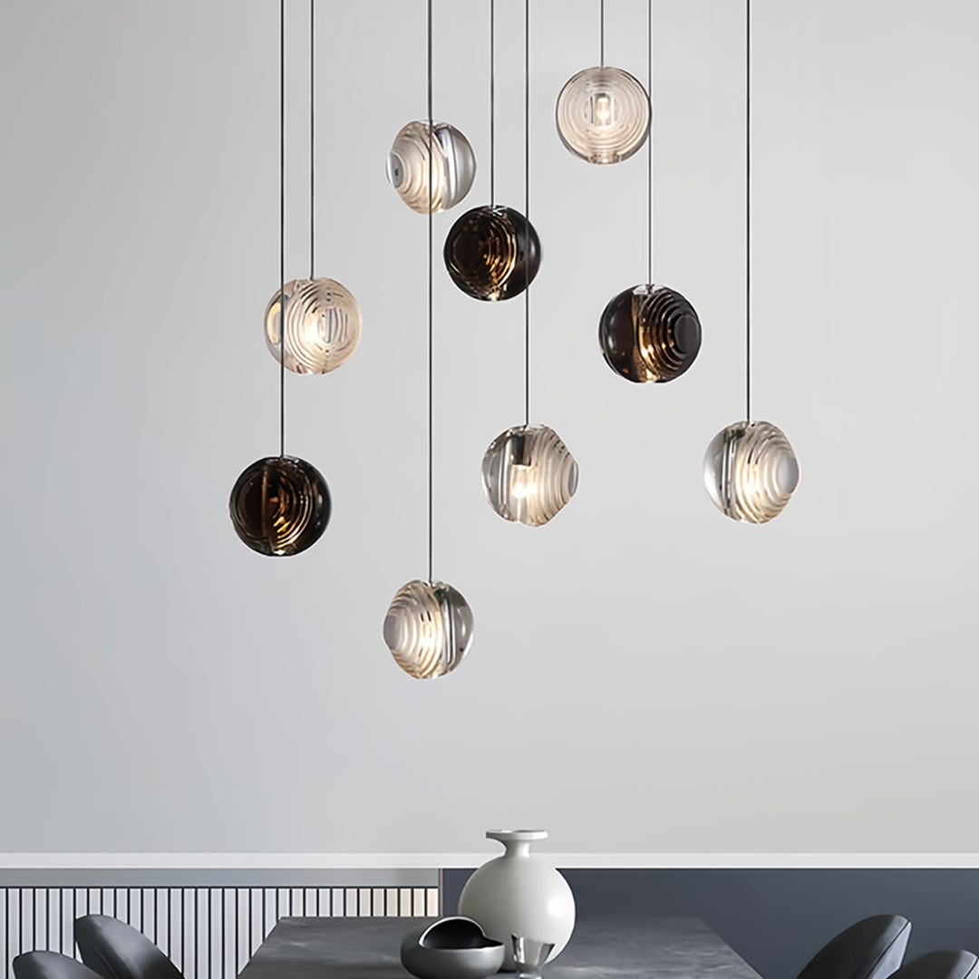 Aureon smoked glass sphere pendant light against a white wall, modern minimalist interior