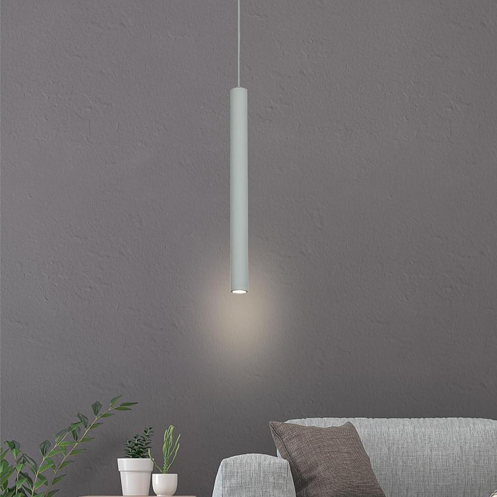 Aureon slim cylinder LED pendant light in white hanging above a kitchen island in a modern interior