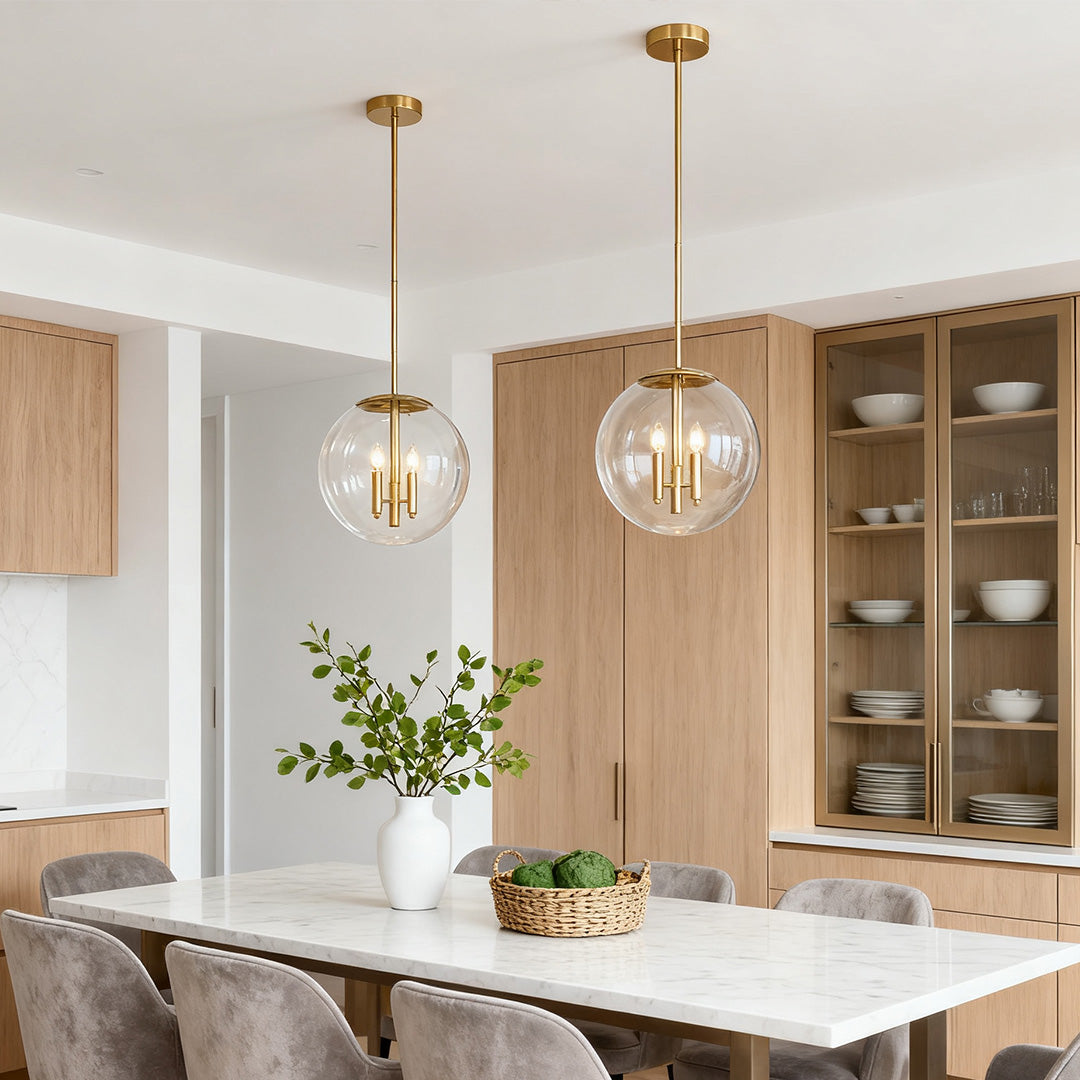 Exposed bulb clear globe pendant light above wood cabinetry in a contemporary kitchen