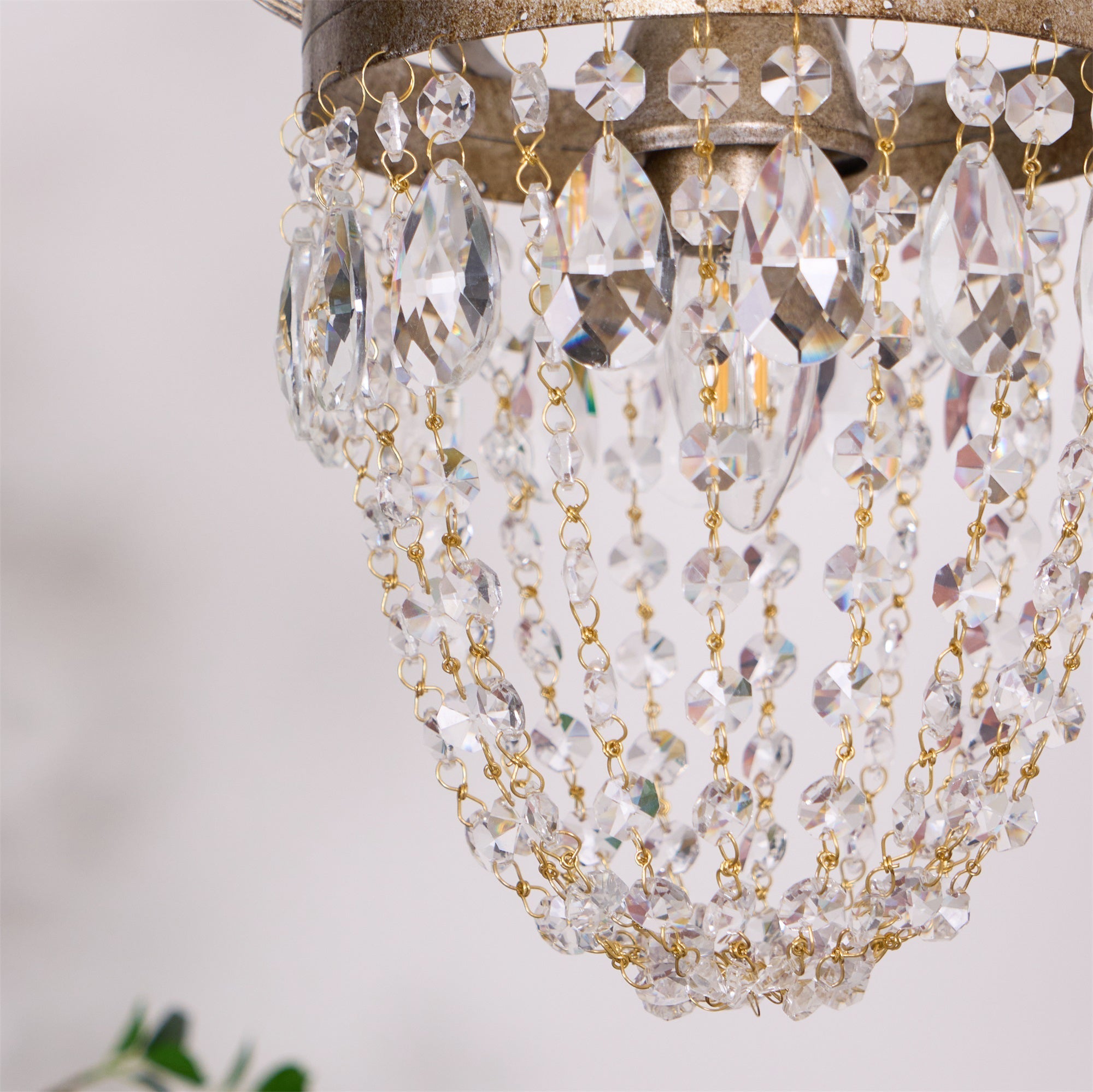 Glass teardrop crystal chandelier in modern interior, silver finish detail