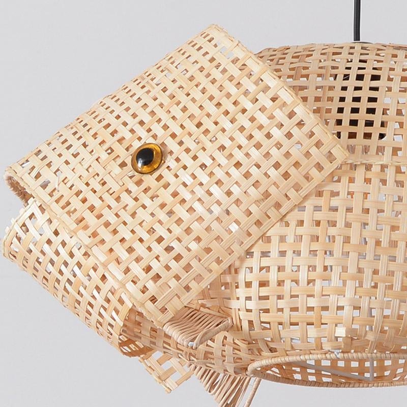 Fish-shaped bamboo pendant light casting soft layered shadows in a stylish room
