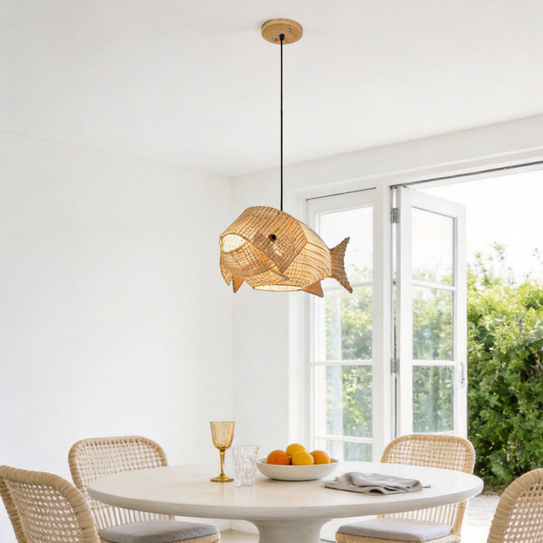 Woven bamboo fish pendant light above a modern dining table