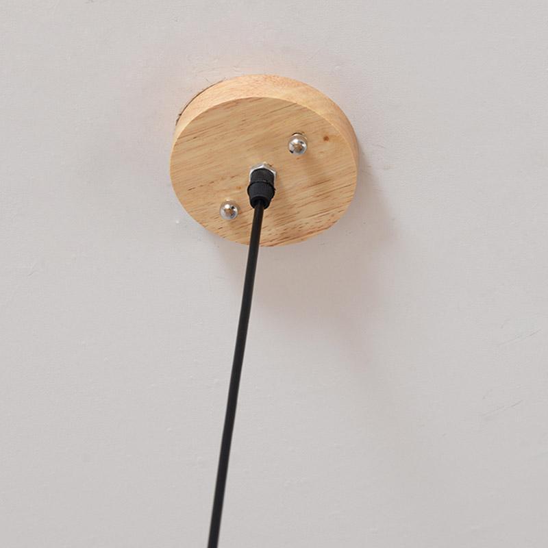 Woven bamboo ceiling pendant light against a white ceiling