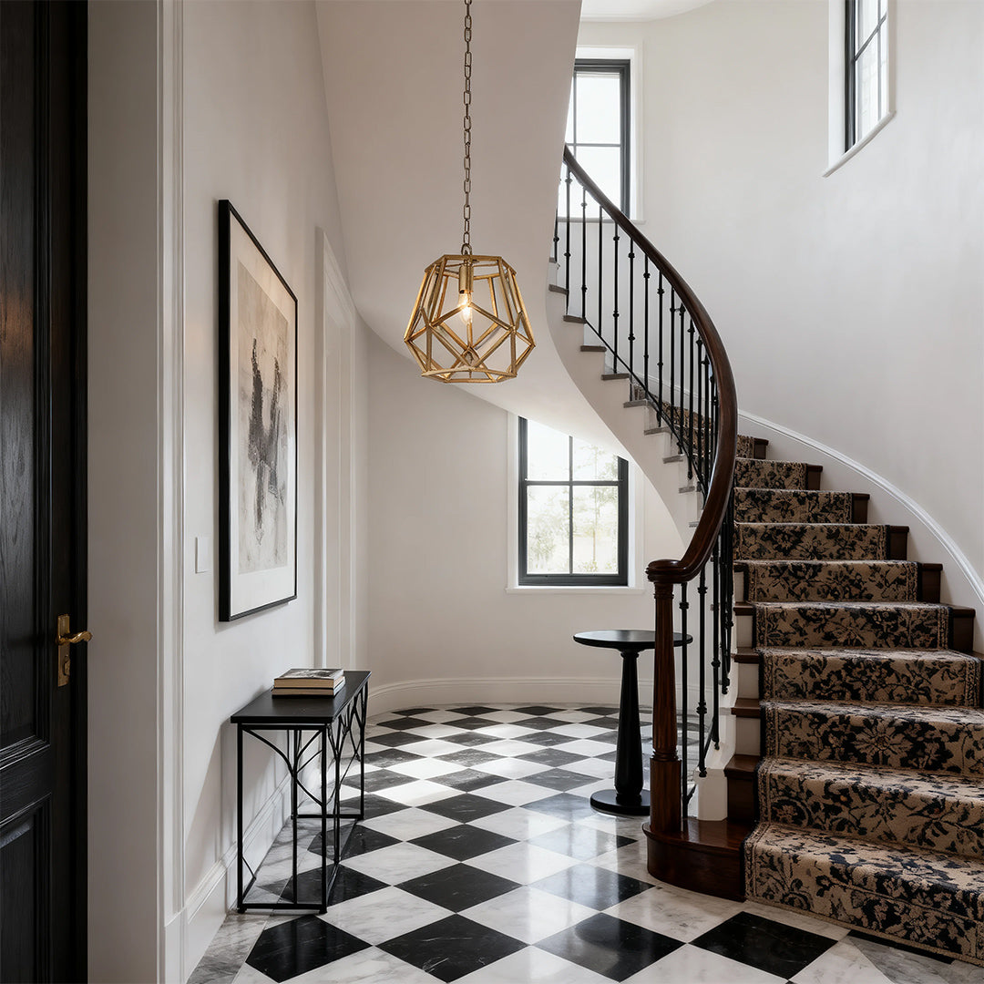 Gold cage pendant light in a geometric foyer with checkerboard floor and spiral staircase