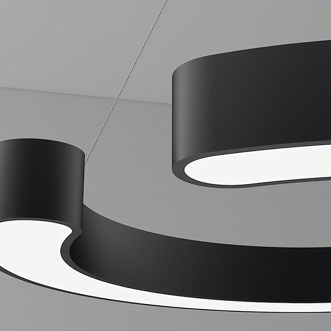 Aureon pendant light angled view showing curved dual-tone frame and canopy detail