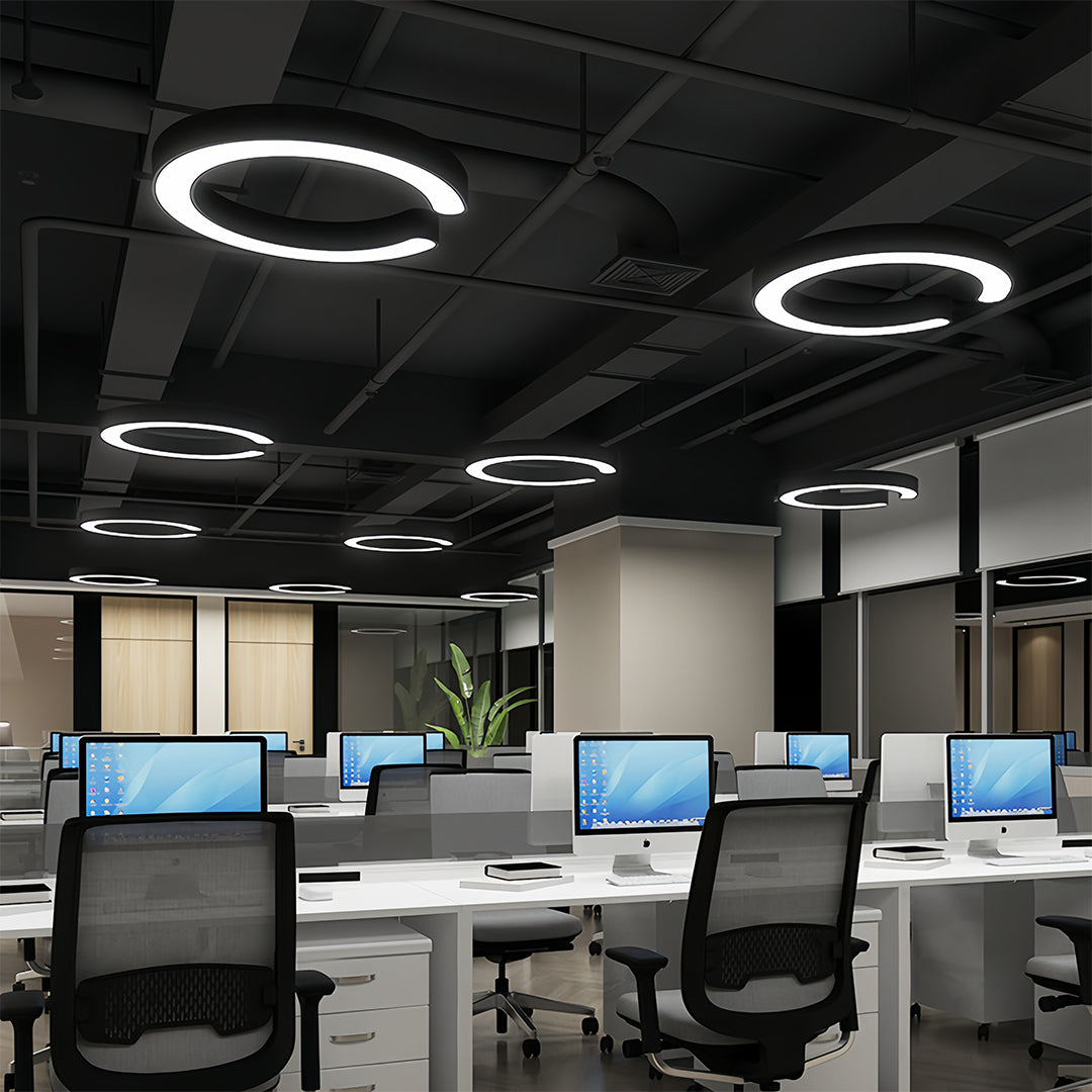 Aureon black ring pendant lights in a modern open-plan office workspace