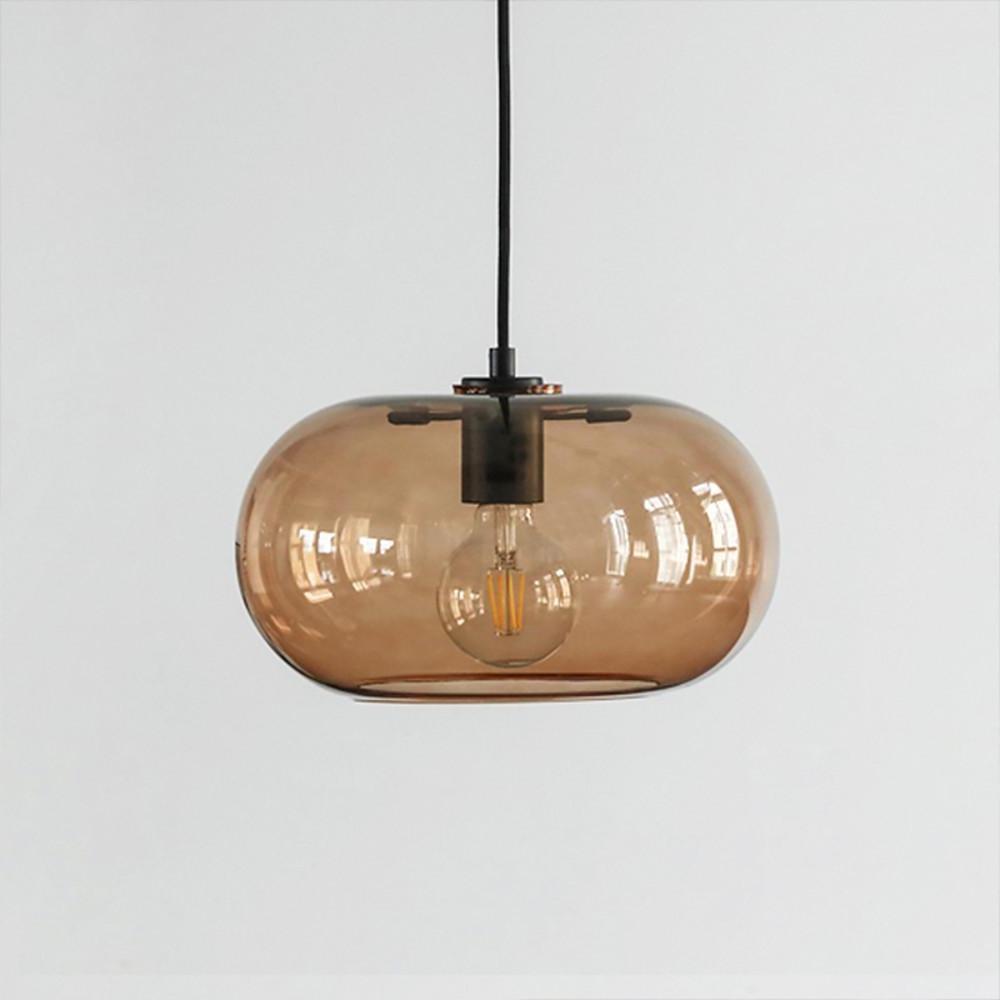 Aureon pendant light in transparent glass finish, shown in a bedroom setting