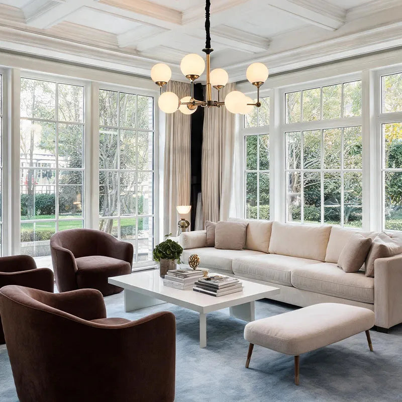Auréline branching brass chandelier in a luxury room setting, warm ambient light