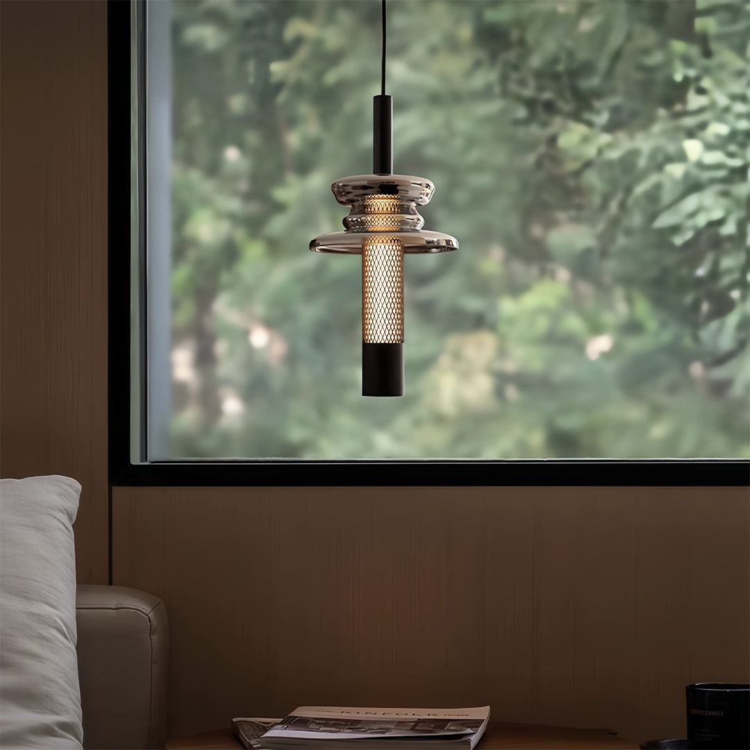 Aureon geometric glass pendant light casting warm ambient light near a window
