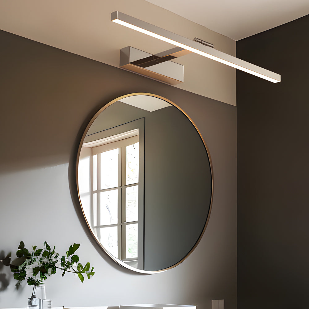 Polished vanity light bar mounted above a round bathroom mirror in a contemporary interior