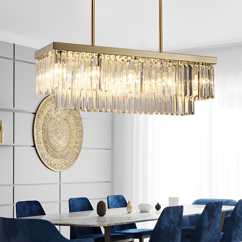 Close-up of crystal bar shades and gold frame on a modern rectangular chandelier