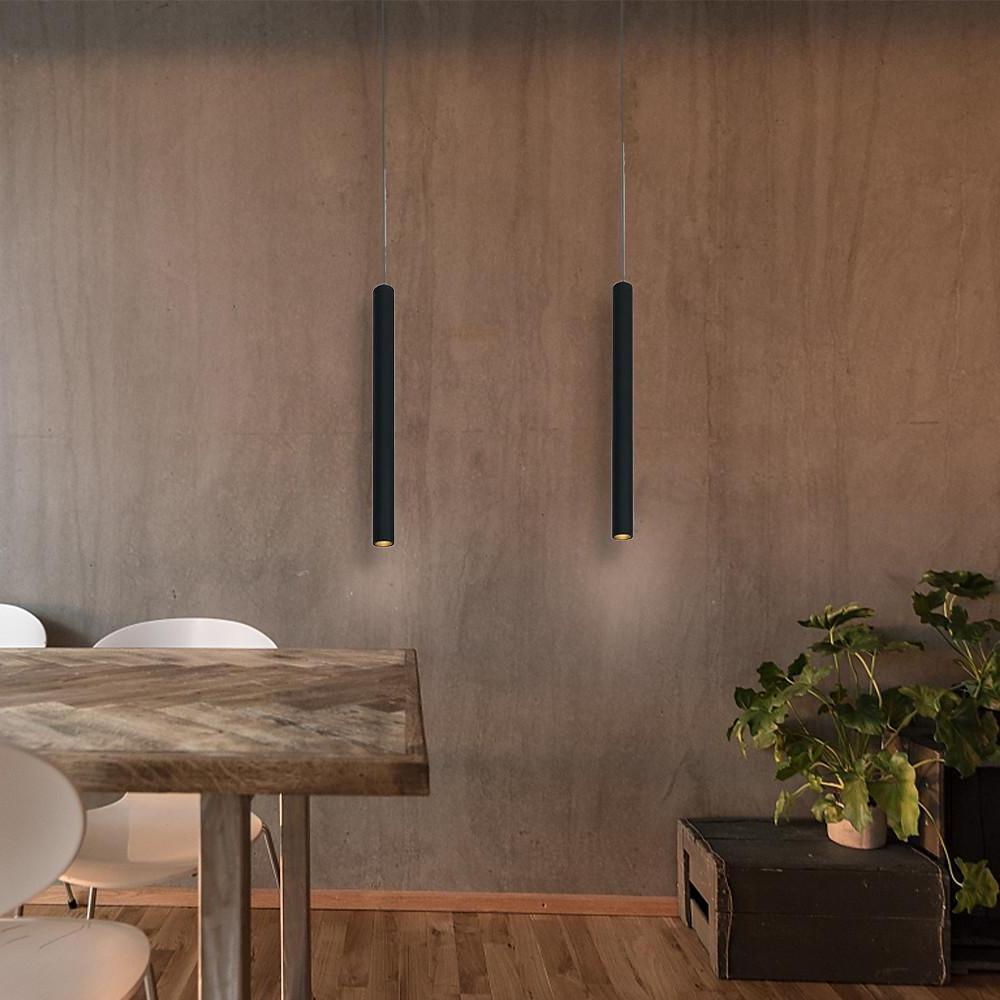 Aureon pendant light in white installed above a dining table in a minimalist contemporary room