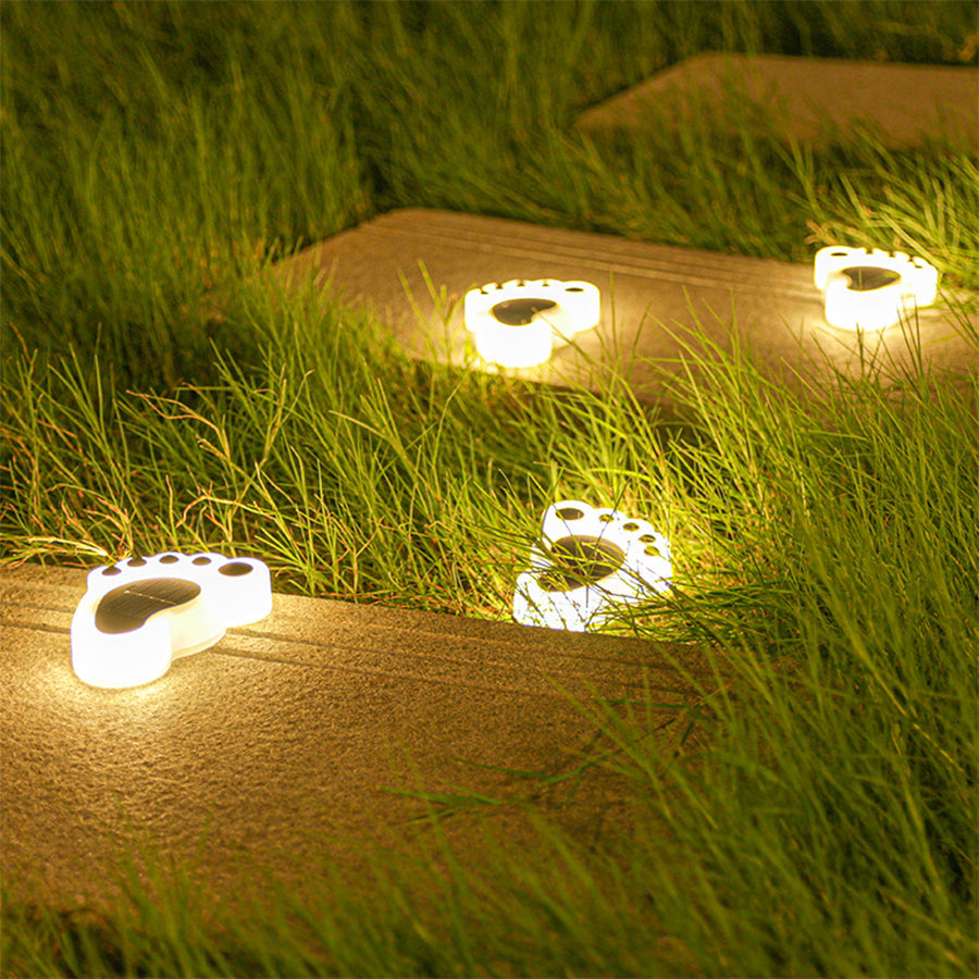 Illuminated Solvara solar footprint garden lights glowing along an outdoor path at night