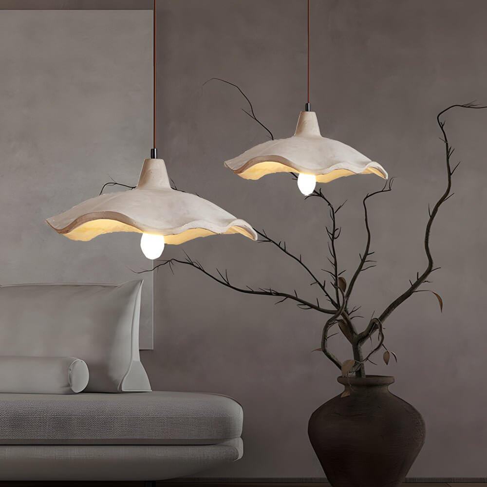 Aureon 15.7-inch cement pendant light casting warm downward light in a dining room