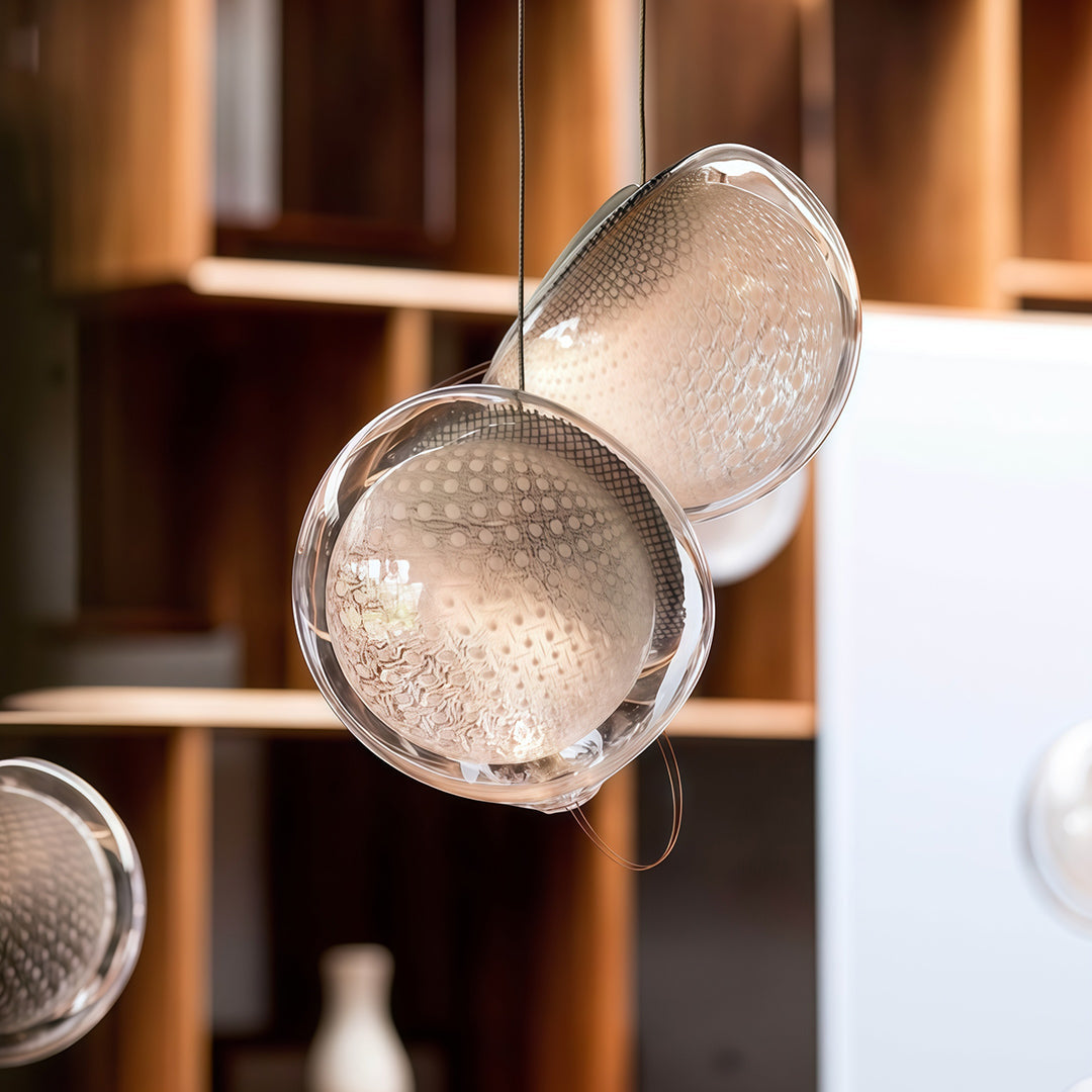 Aureon jellyfish glass pendant light hanging above a dining table in a modern interior