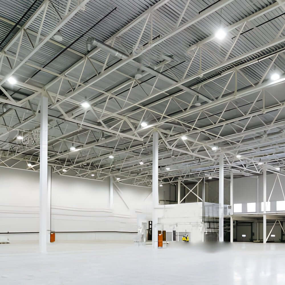 Aureon industrial pendant lights installed over large storage area with high ceilings and metal racking