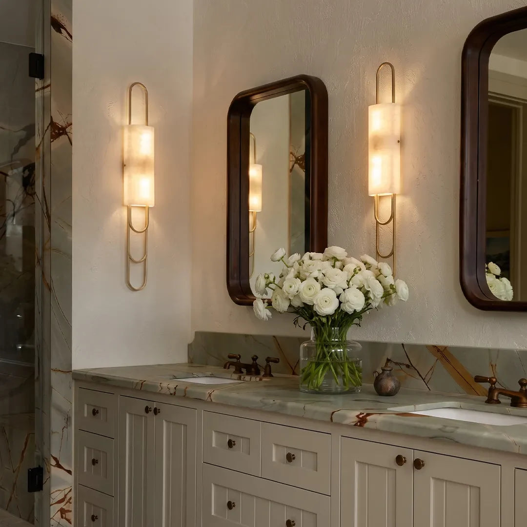 Niva LED marble wall sconce installed beside bathroom mirrors, black finish
