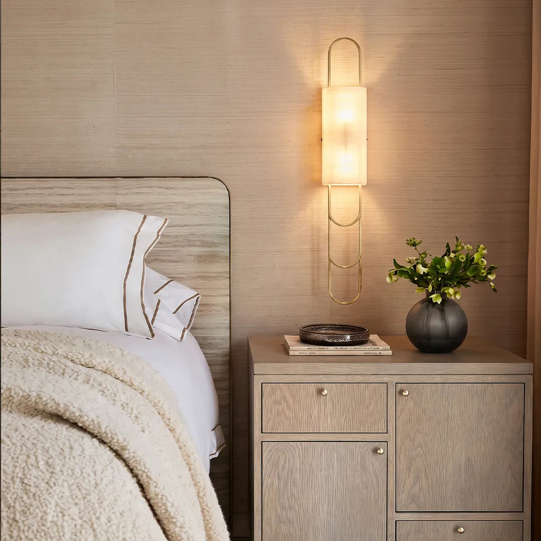 Niva marble LED wall sconce mounted beside a bedside cabinet in a modern bedroom