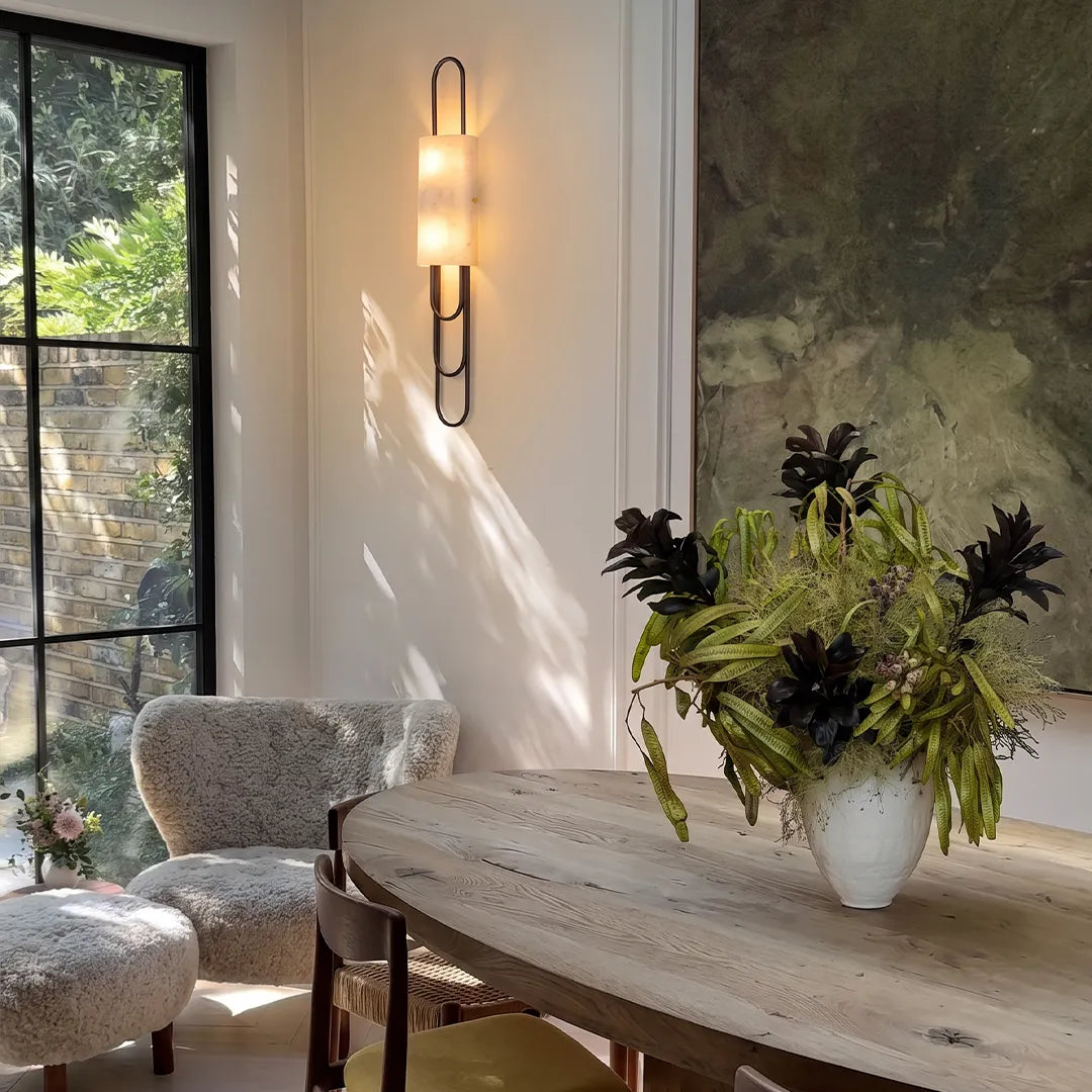 Niva LED marble wall sconce in a contemporary dining area, gold finish
