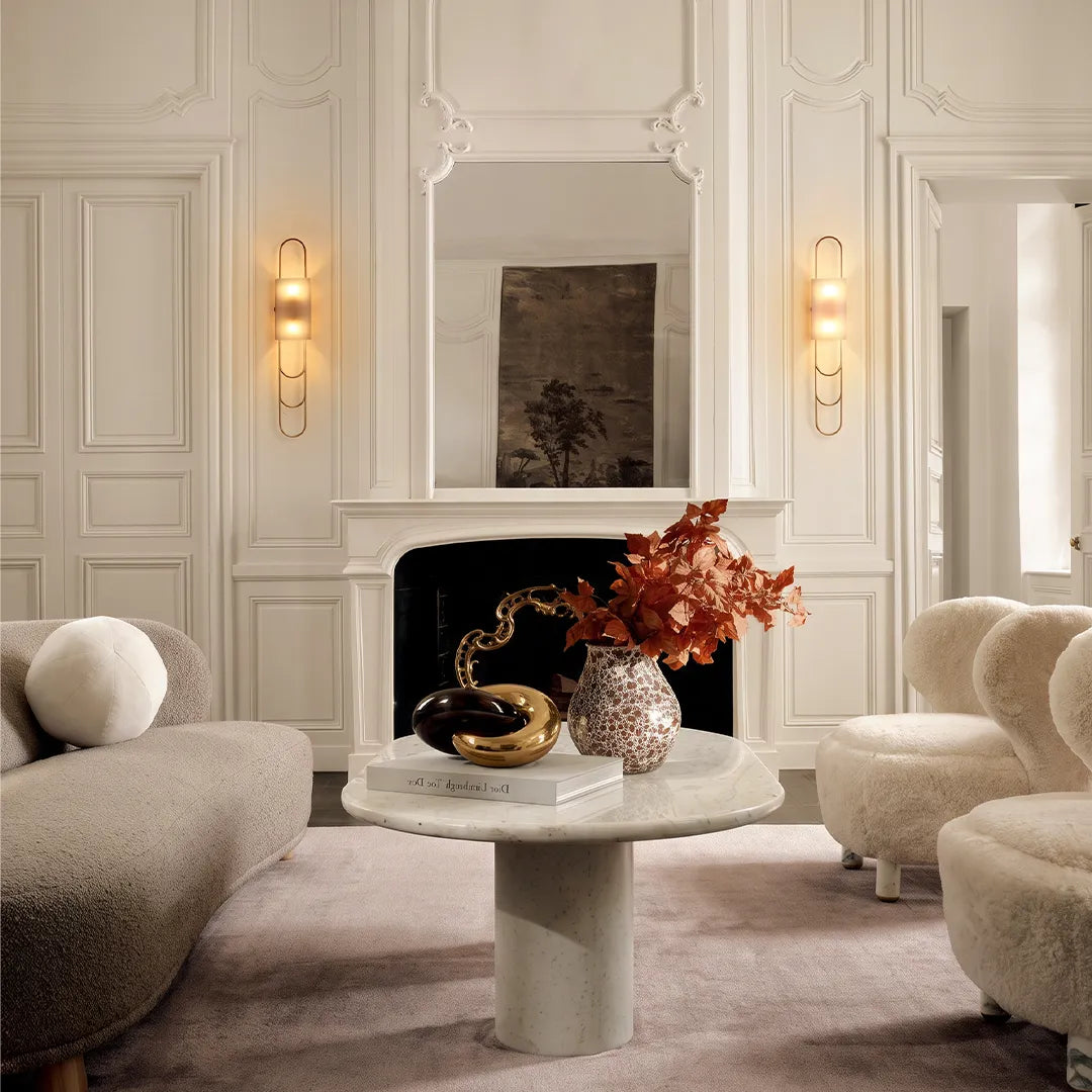 Niva marble wall sconce mounted on a fireplace feature wall in a modern living room