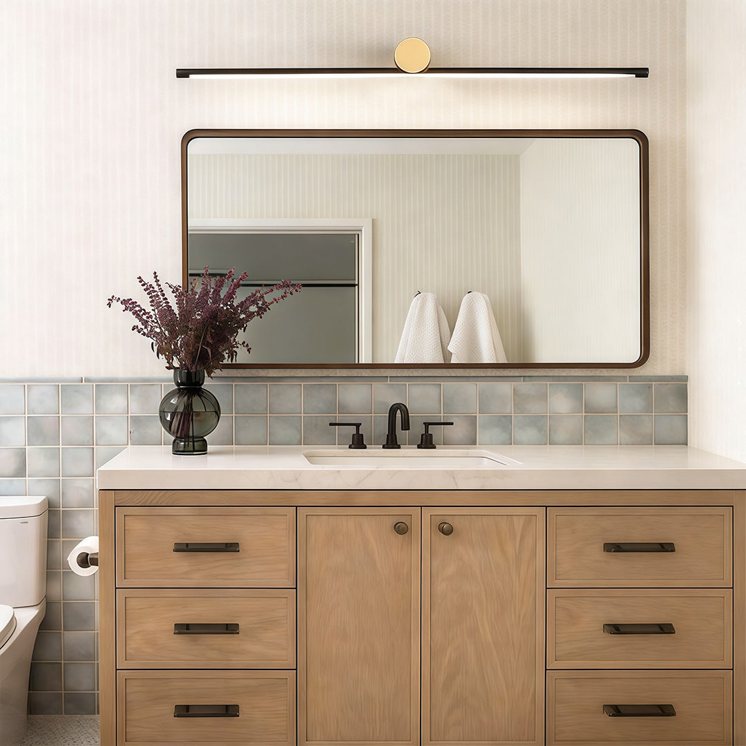 Viora two-tone vanity light bar in a modern bathroom with wood cabinetry