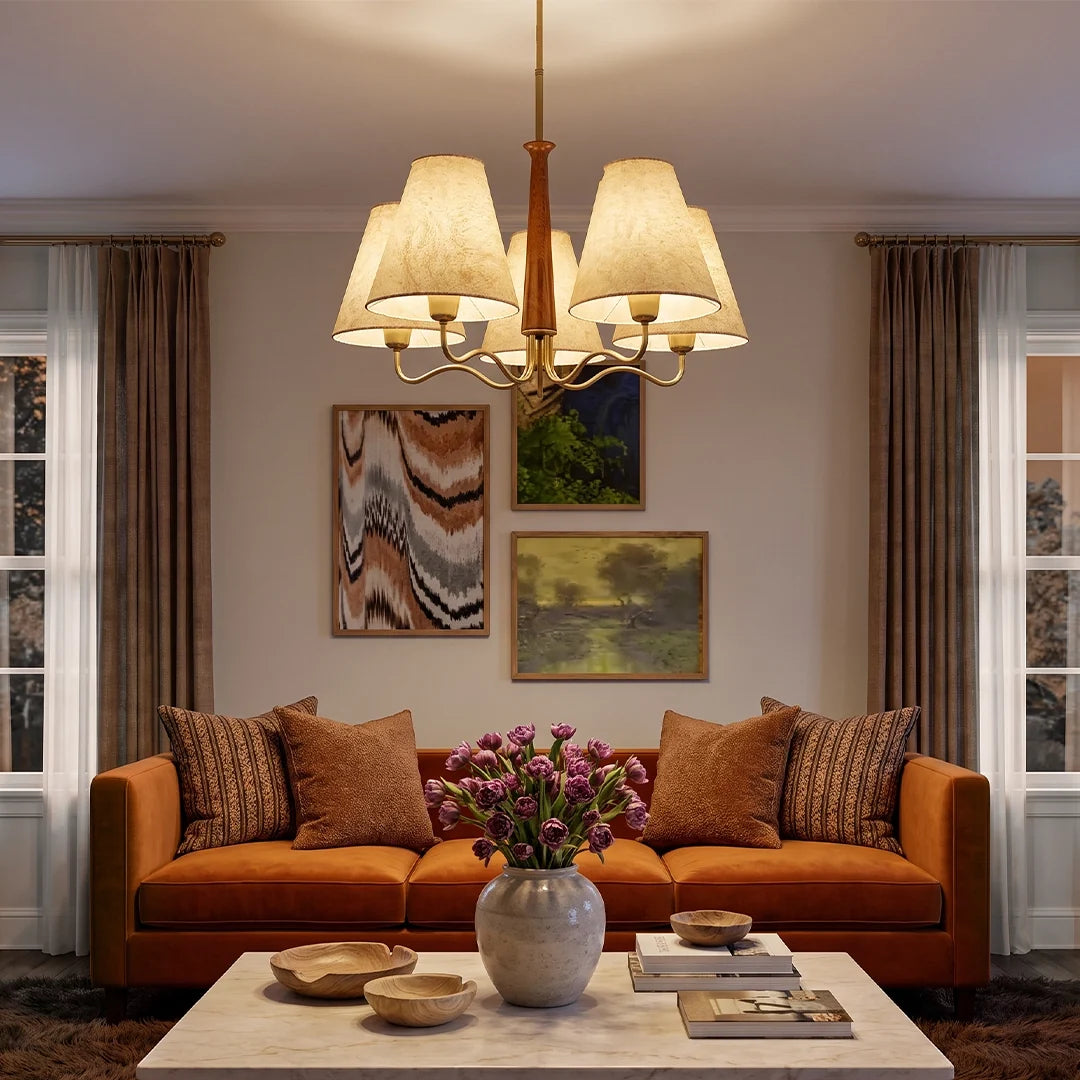 Auréline five-light fabric chandelier above a living room seating area, iron frame with parchment shades