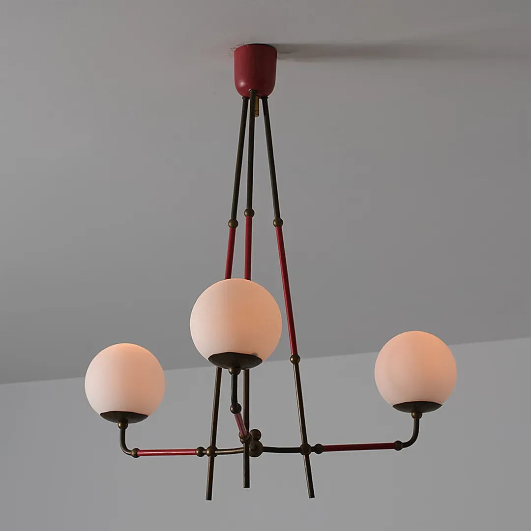 Auréline three-arm iron chandelier switched on, showing warm G9 illumination through glass shades