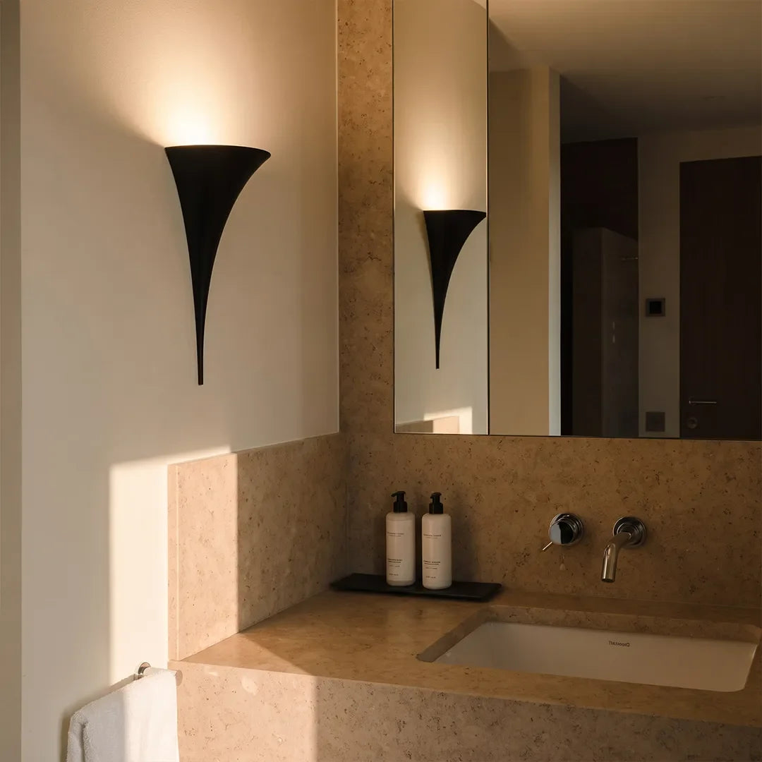 Black finish brass wall sconce in a modern bathroom wall lighting application