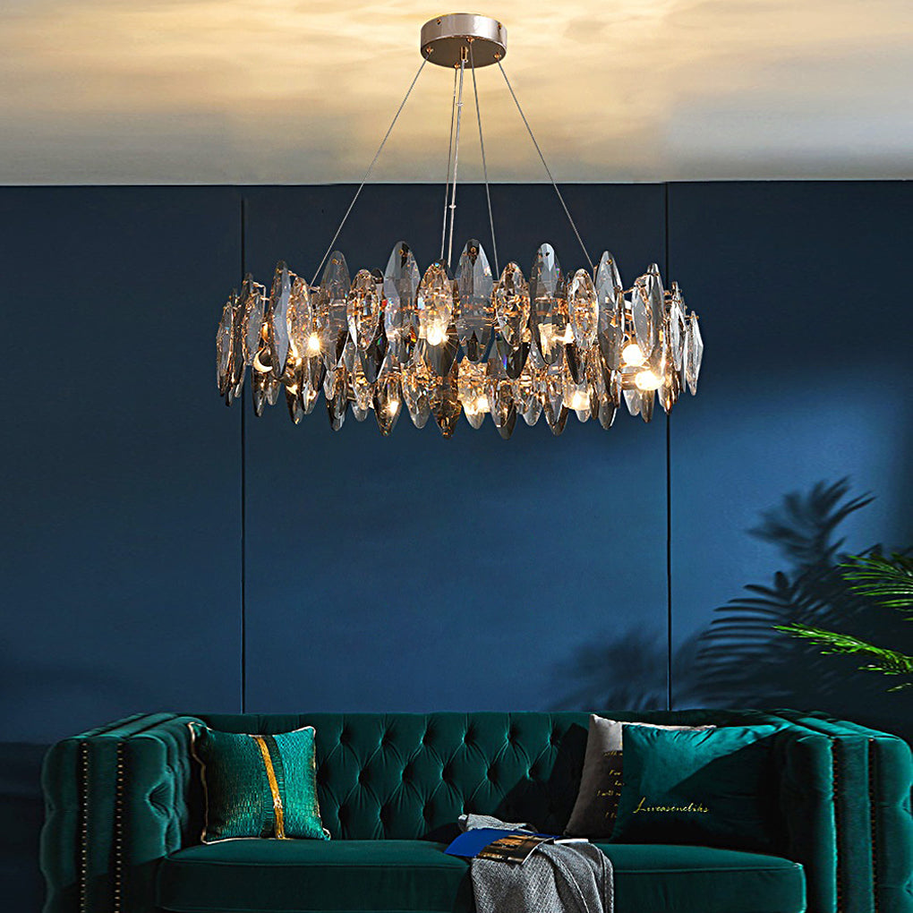 Auréline smoky crystal ring chandelier above a green velvet sofa in a modern living room