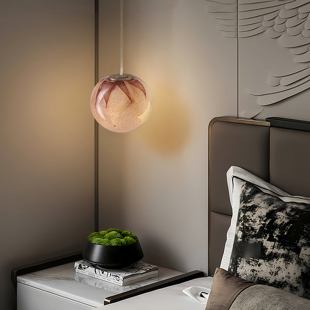 Modern copper glass globe pendant light in a contemporary interior
