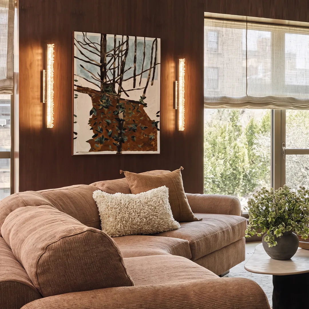 Niva crystal wall lights creating warm ambient light in a cosy modern living room
