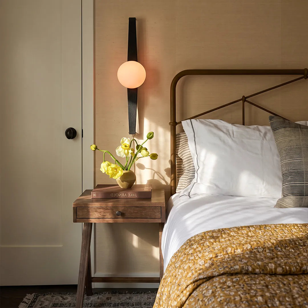 Niva wall sconce as a bedside reading light beside a minimalist bedroom table