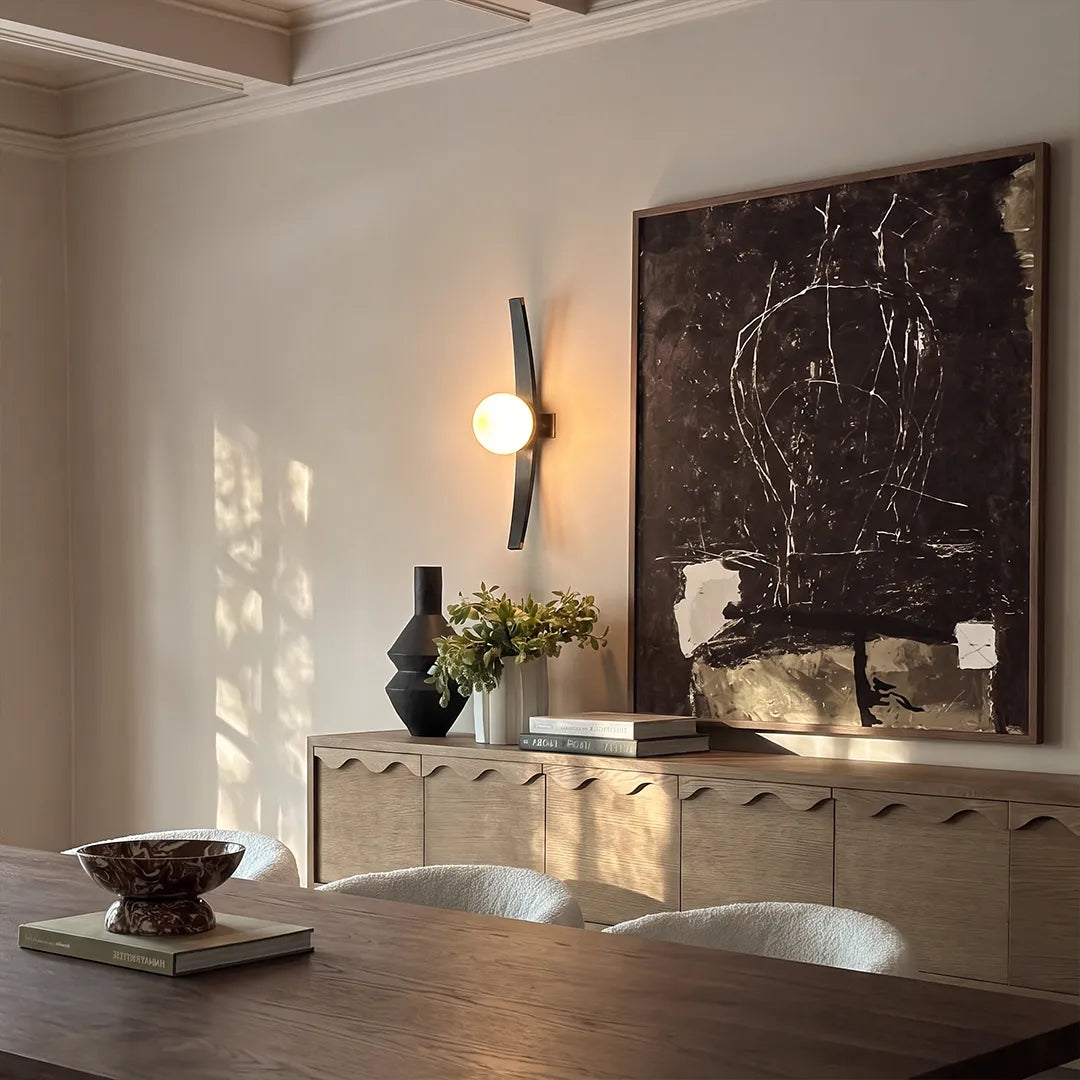 Niva wood frame glass wall sconce above a living room console table, contemporary interior