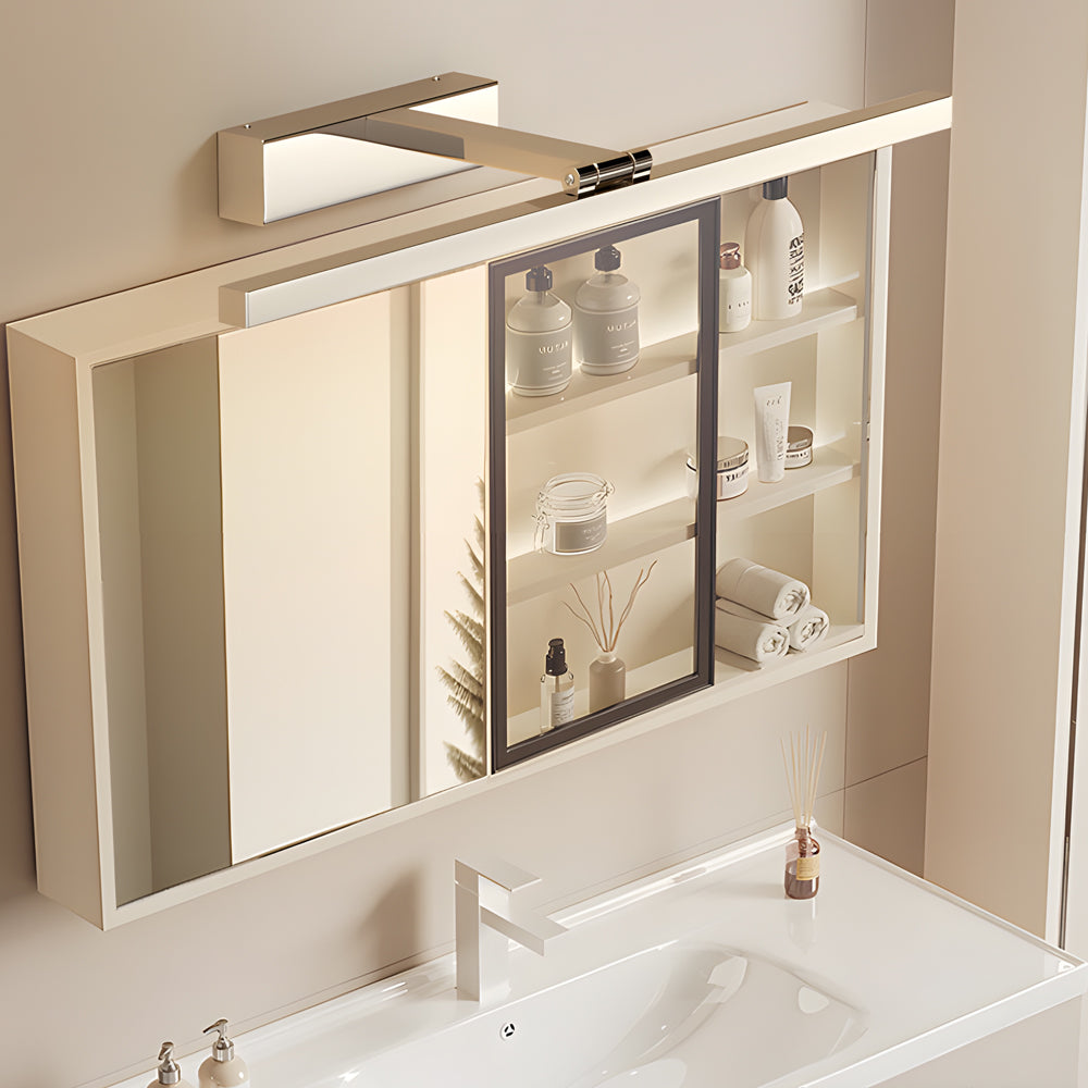 Stainless steel LED bathroom mirror light bar beside a wall-mounted mirror cabinet