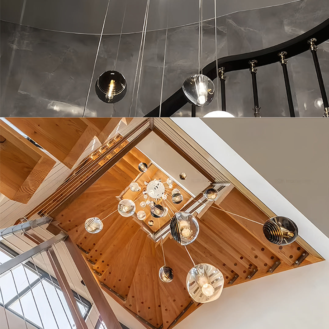 Aureon smoked glass pendant lights in a staggered arrangement over a modern staircase