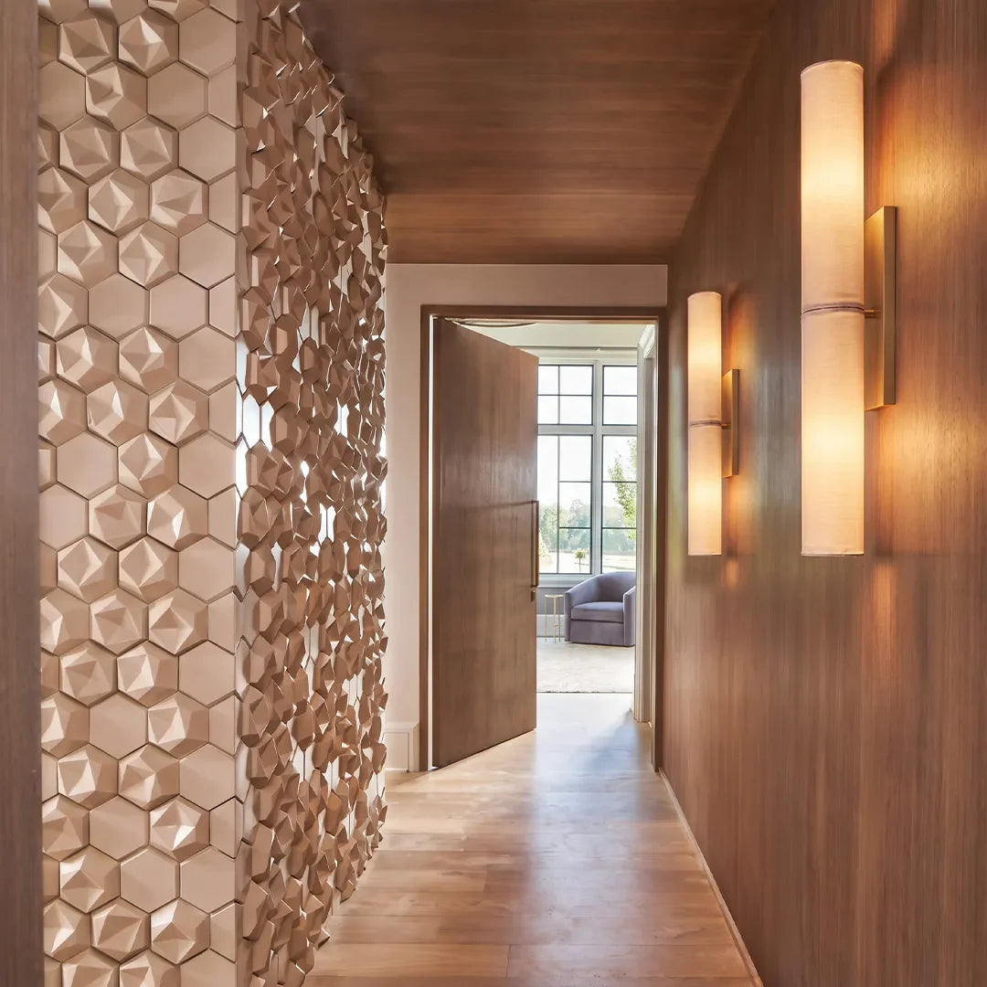 Marble cylinder wall sconce providing ambient LED light in a modern hallway corridor