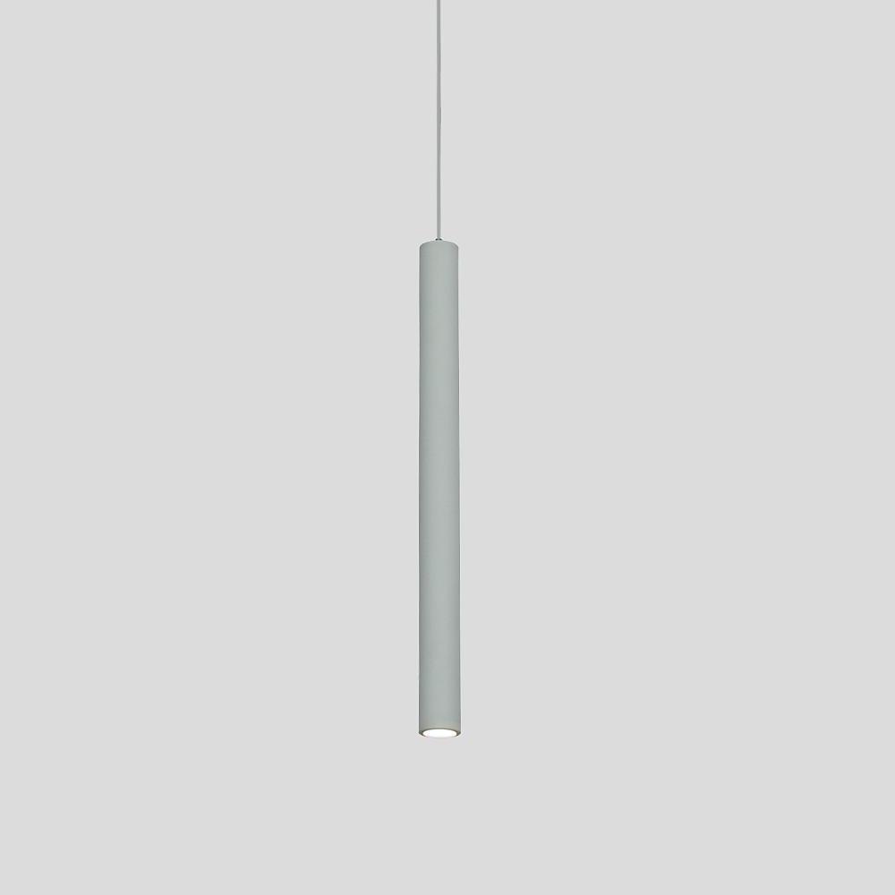 Aureon slim pendant light in white, warm white light on, hanging in a living room setting