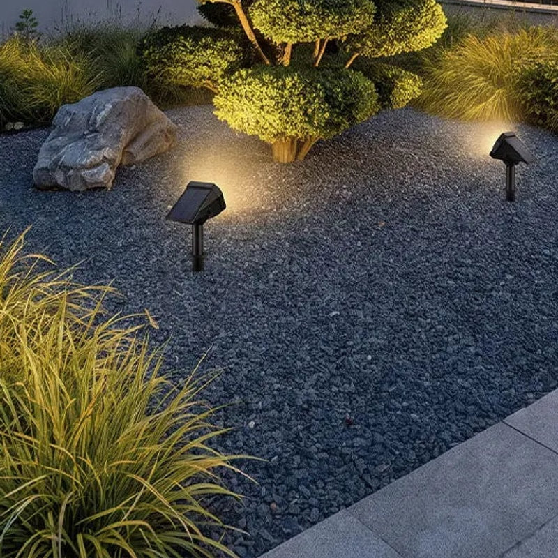 Solvara solar stake garden light installed in soil beside a flower bed