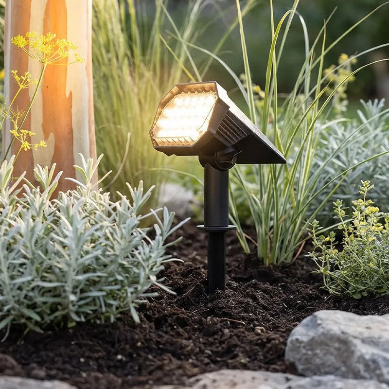 Solvara solar ground stake light aimed at a garden pathway with warm white LED