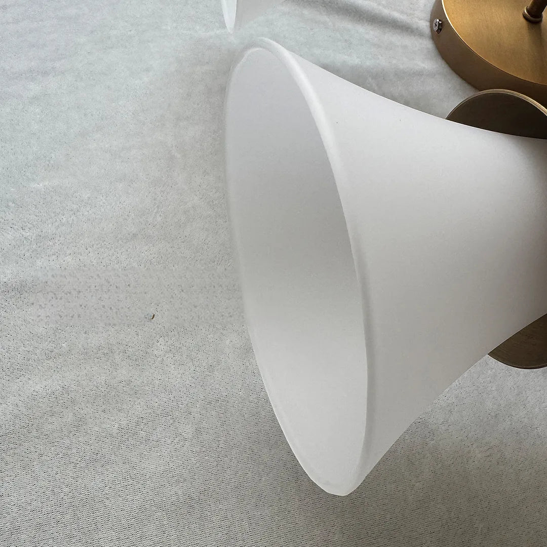 Close-up of Niva frosted white trumpet glass shade diffusing warm LED light
