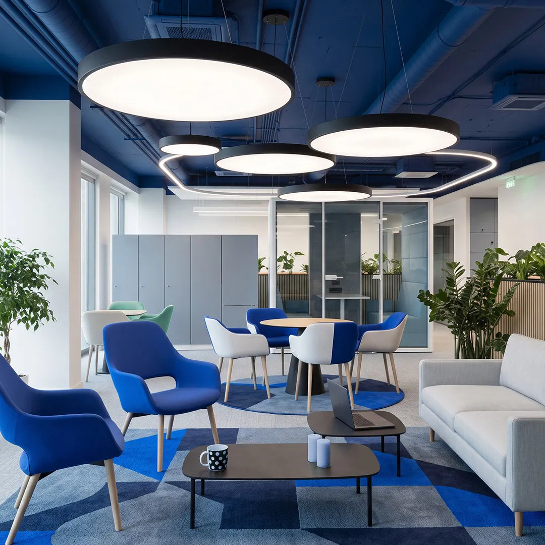 Circular LED pendant light in a contemporary office lounge