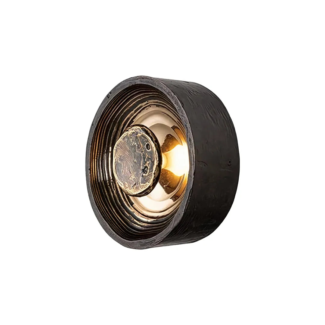 Niva round wall sconce in black copper finish, product view against a dark background