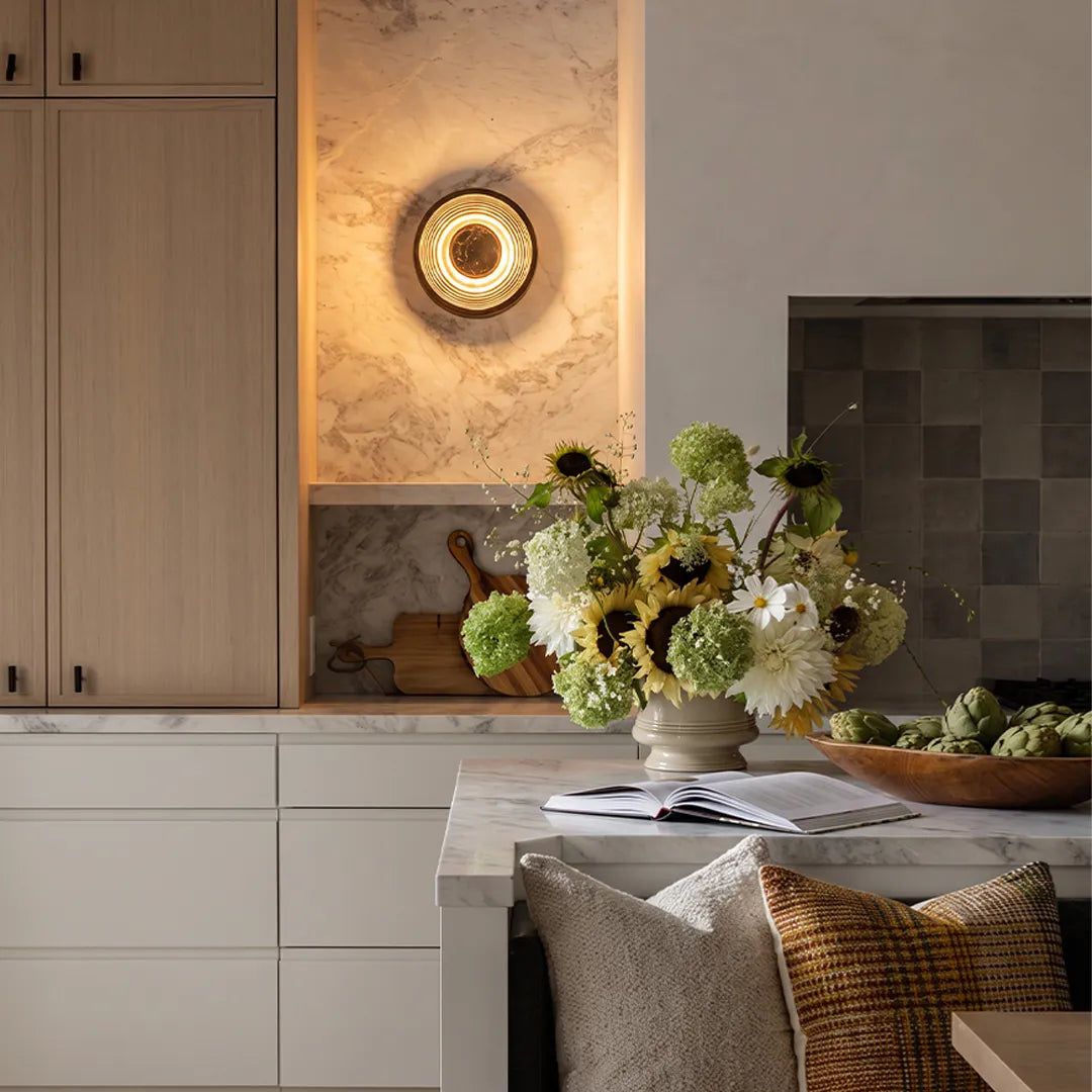 Niva black copper round wall sconce used as accent lighting above a kitchen counter