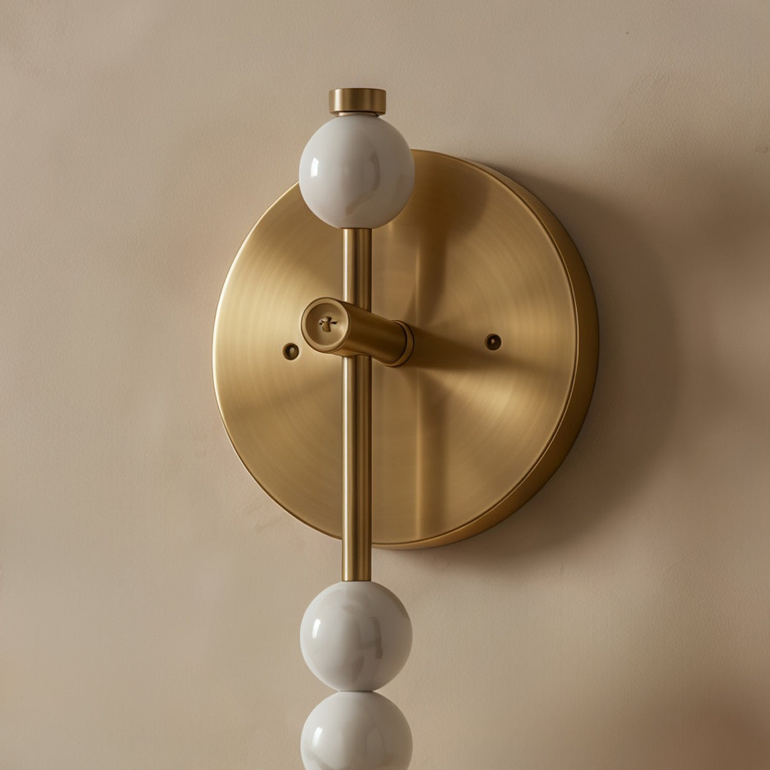 Alure wall sconce backplate and brass arm detail, decorative iron wall light close-up