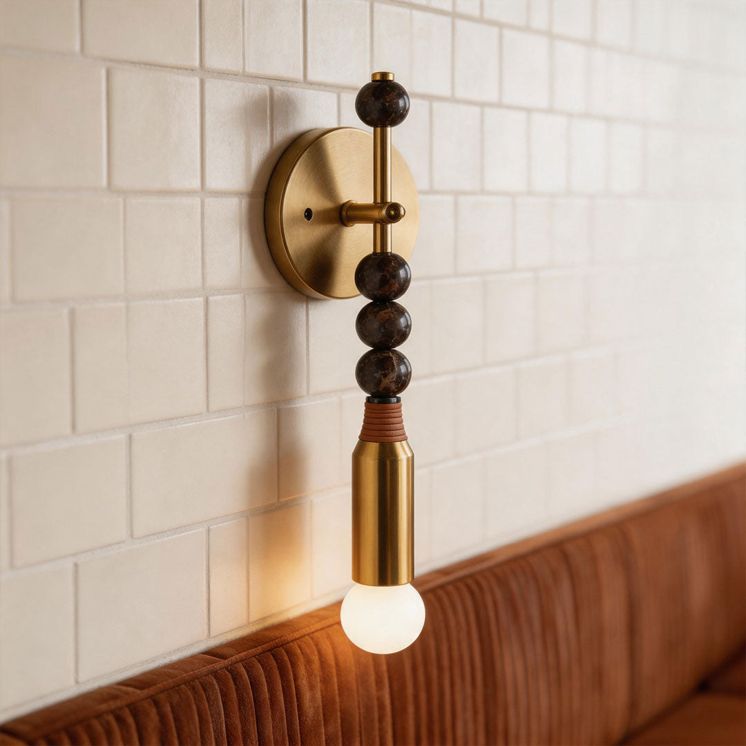 Alure copper and brown wall sconce with marble-effect globe on a tiled wall, decorative indoor light