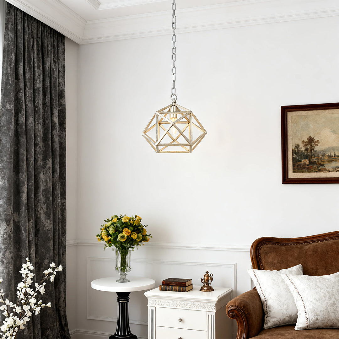 Single Aureon gold metal pendant light casting warm patterned light, accent view