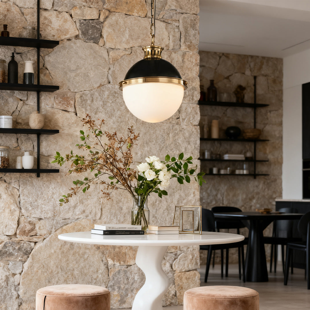 Single Aureon opal glass ball pendant light against a rustic stone wall interior