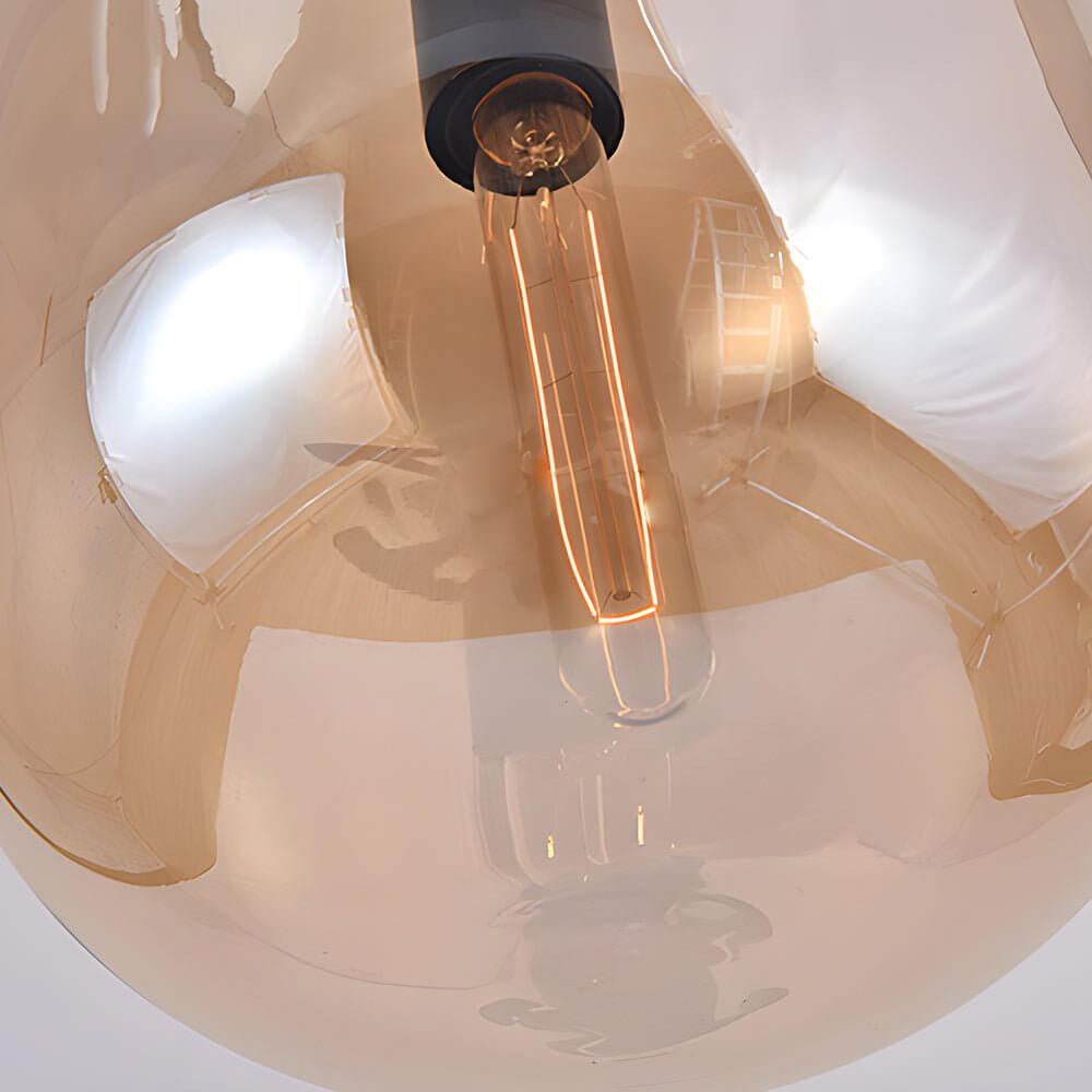 Aureon amber glass pendant light casting warm ambient glow in a dining room