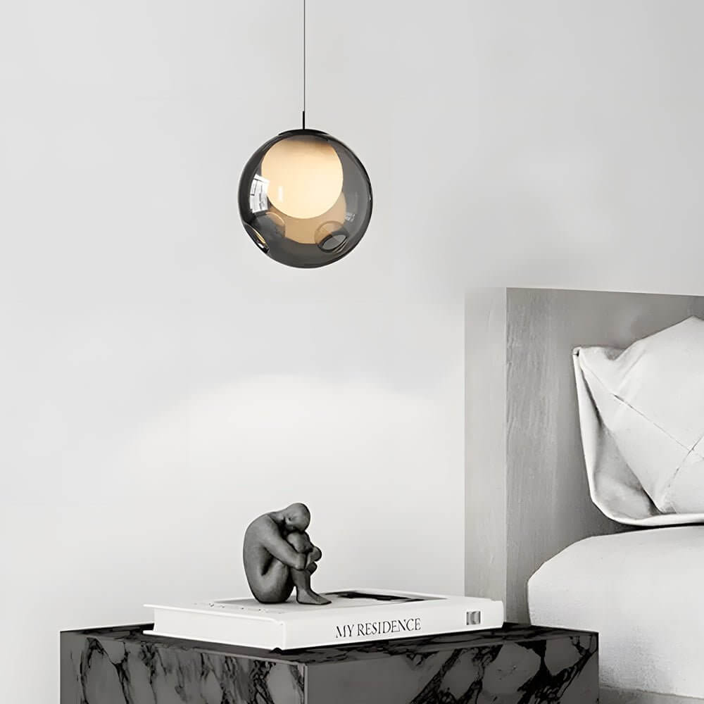 Single Aureon smoked glass pendant light used as a bedside lamp in a modern bedroom