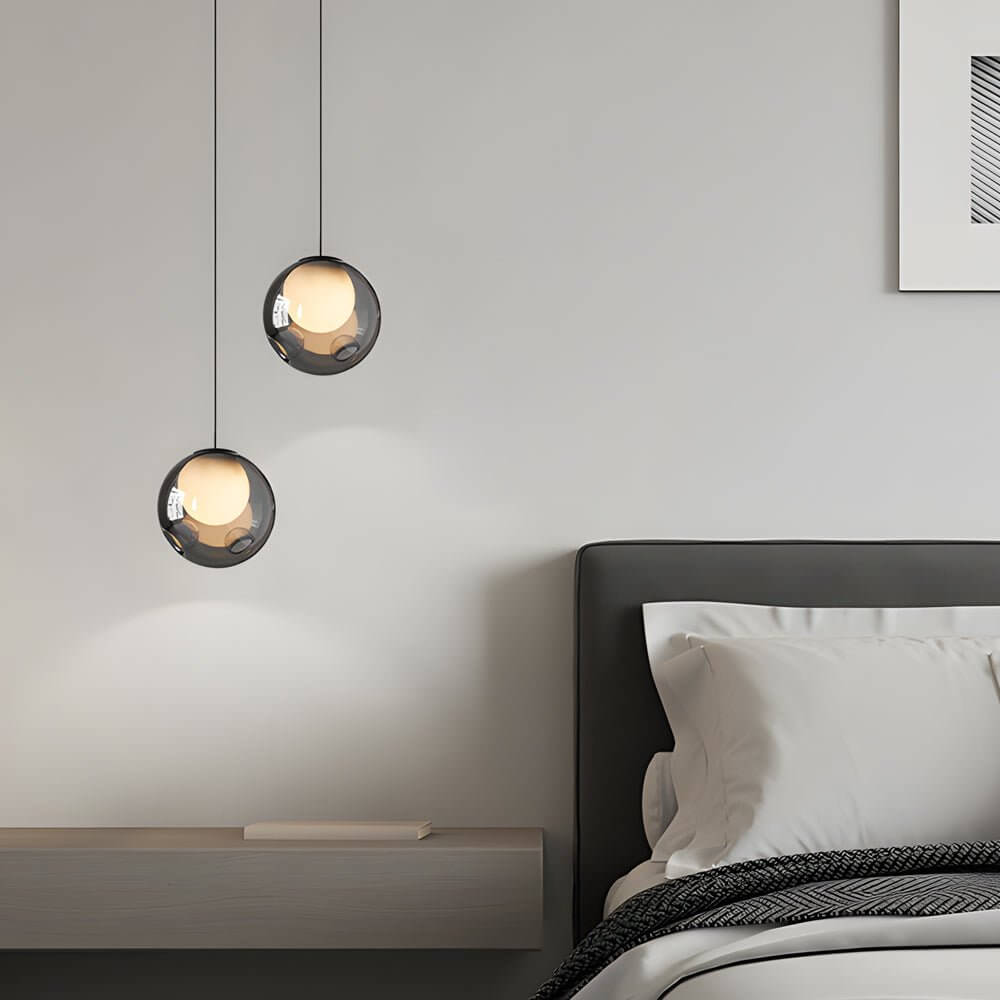 Staggered arrangement of smoked glass globe pendant lights in a modern bedroom interior
